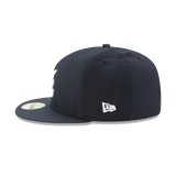 Navy blue fitted baseball cap with flat brim and white New Era logo on the side