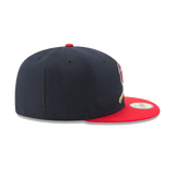 Navy blue fitted baseball cap with red flat brim and side sports team logo