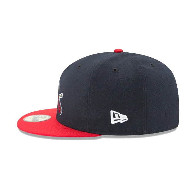 Navy blue snapback cap with red flat brim, side logo embroidery, and sticker on visor